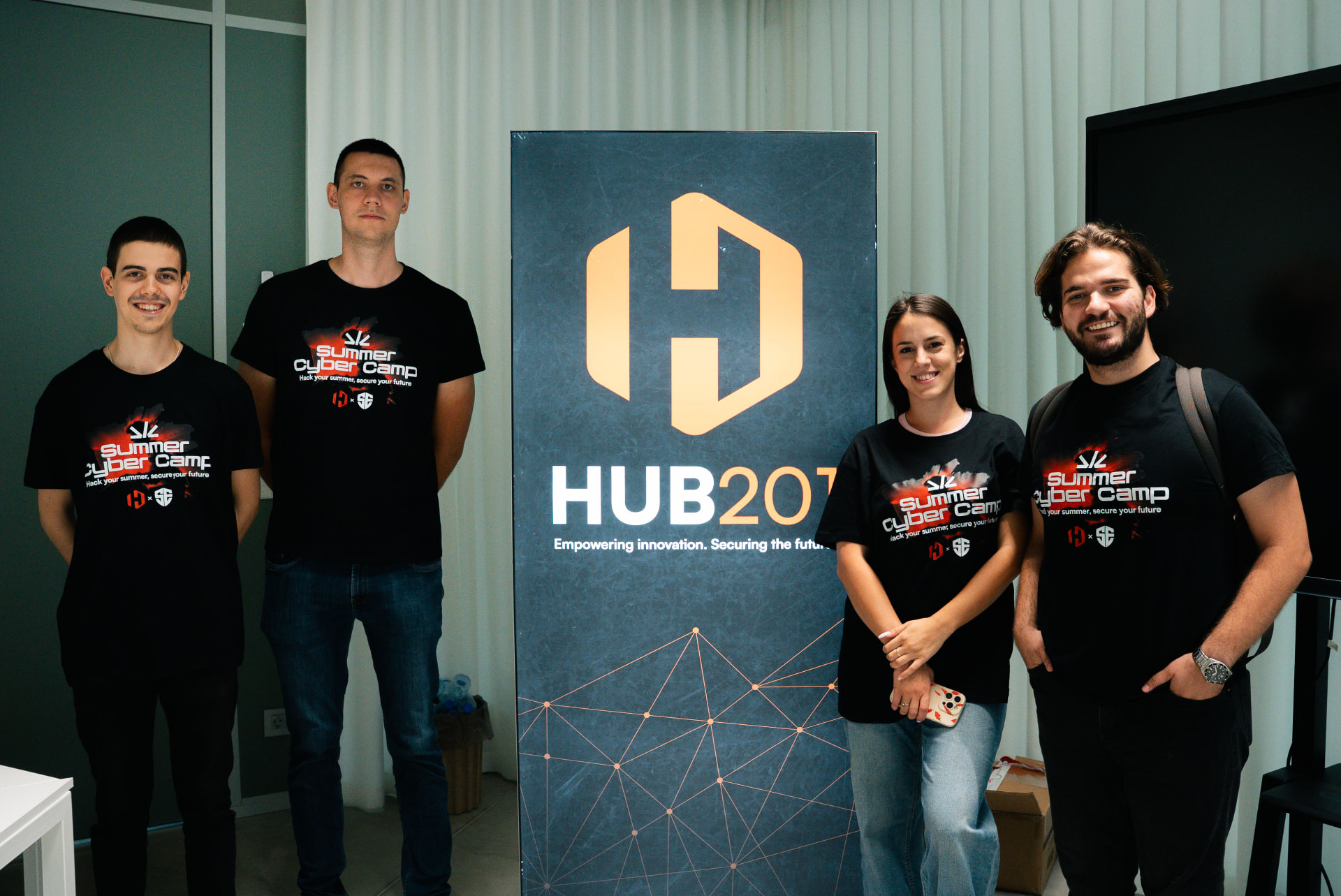 Summer Cyber Camp team in front of the HUB201 banner